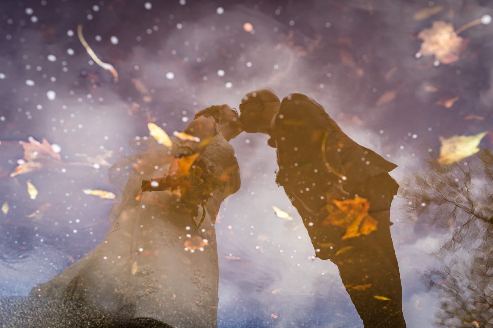 hochzeit regen pfütze brautpaar kuss